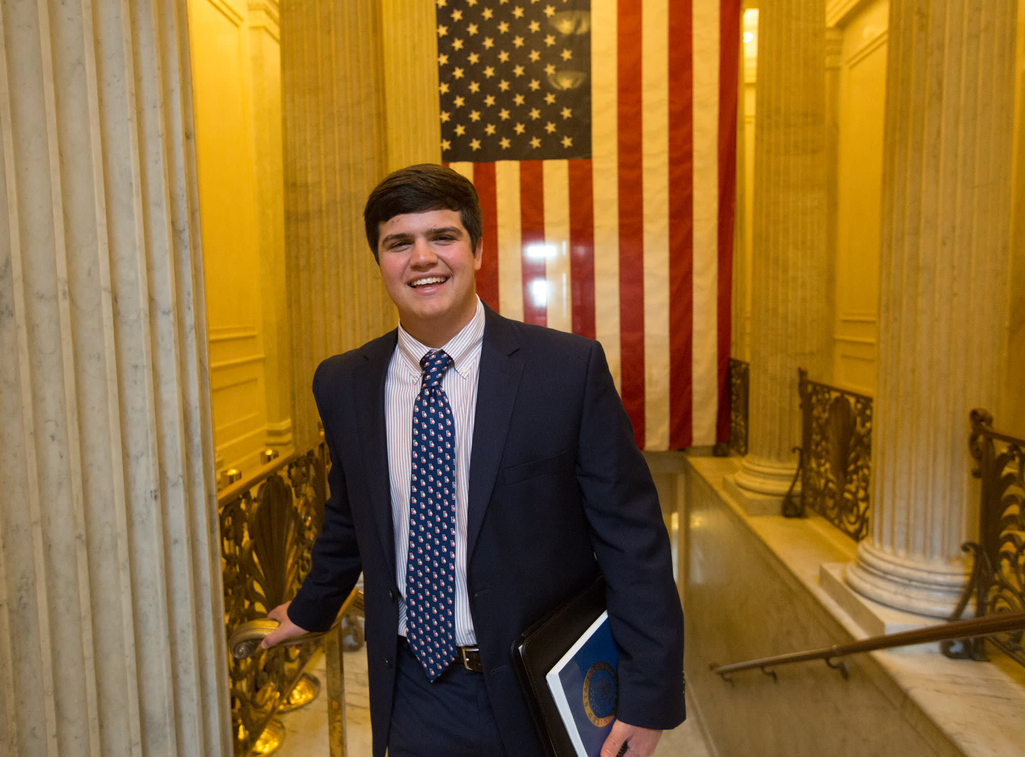 Episcopal High School — student portrait by the flag